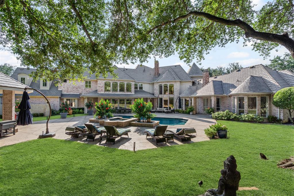 On a prominent corner in prestigious Preston Trails, this 6,800 sq.ft estate defines refined living and is situated on .88 of an acre. Behind its stately facade, a dramatic foyer opens to elegant living and dining rooms with wet bar. Perfect for entertaining and everyday family life. Light filled family room with walls of windows opens to breakfast area and chef’s kitchen featuring Thermador appliances, designer lighting, generous island and exceptional storage. Primary suite offers vaulted ceilings, built in shelves, sitting area and fireplace. Spacious, spa like master bath features a soaking tub with a view, walk-in shower and separate walk-in closets. Downstairs guest suite with private bath. Upstairs features theatre game room with wet bar kitchenette, additional living space and three ensuite bedrooms. Resort style backyard offers multiple outdoor entertaining areas for year round enjoyment, sparkling pool, gazebo with fireplace, plenty of green space, mature trees with landscape lighting truly create a one of a kind experience. Ideally located close to elite private schools, DFW & all that Dallas has to offer.