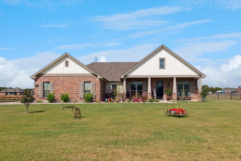 Beautiful home on 1.5 acres with 3 bay RV, boat, storage outbuilding.  Home shows like new, really.  Open floor plan, high ceilings, lots of natural light.  Kitchen has large island, stainless steel appliances, farm sink and a great number of cabinets and counter top space.  Living is open to kitchen, wonderful views of back yard and a brick wood burning fireplace with raised hearth.  Master is big with separate vanities, shower, garden tub, plenty of cabinets, linen and an oversized walk in closet.  This walk in closet is connected to the utility room where there are even more cabinets and counter tops and a sink. Two bedrooms on other side of home shard a full bath.  The mud room entrance from the garage also has a work desk.  The office is actually a dining room that works great as either an office or dining.  The outbuilding is 40x30 and has 3 high bay doors for large trucks, RVs or any fun equipment you want to enclose or use it as a workshop.  Property is entirely fenced. Very quiet area for country living with Fiber Internet to stay connected.  Great place to call home.