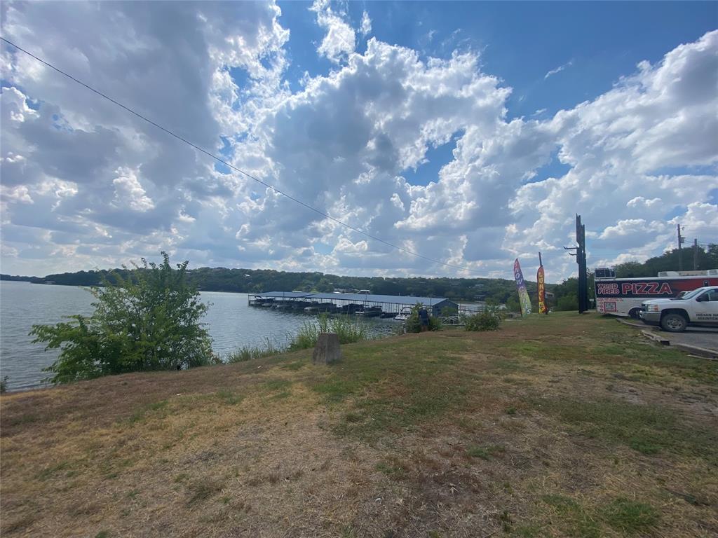 Large Lot ready to build! Just under .4 acres, with some nice trees. The community of Indian Harbor is located along the shores of Lake Granbury and boasts many amenities.  There are two boat launches, a marina with gas, a recreation center, community pool with clubhouse, subdivision campground, park, and more!  This lot is large, almost half an acre with frontage on W Apache and Iron Horse. There are many new homes being built in this community.  Rentals and Vacation rentals are allowed. Seller does not have a survey. verify all information in this listing.
