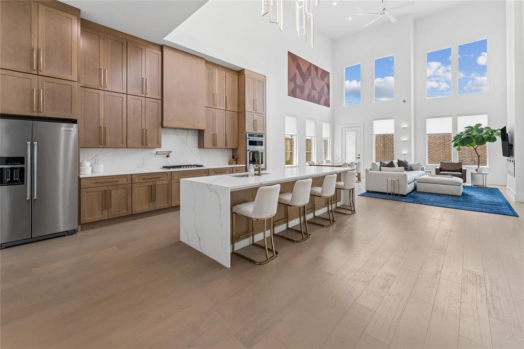 A rare opportunity to own a 2024 Silverkei-built custom residence in Grand Braniff Park. One of only three builder-designed homes, this exceptional property showcases distinctive architecture, custom cabinetry, wide-plank engineered hardwood flooring, designer lighting, and luxurious floor-to-ceiling quartz tile bathrooms. Offering six spacious bedrooms, sophisticated finishes, and grand-scale living spaces, the home delivers an unforgettable first impression. Unlike new construction, this fully completed, highly upgraded home eliminates lengthy build times and costly designer selections. The dramatic two-story living and dining areas flow into a chef’s kitchen featuring custom cabinetry, premium appliances, quartz countertops, abundant storage, and a large island. The private primary suite offers dual vanities, dual toilets, dual walk-in showers, and an oversized closet. Upstairs, enjoy a spacious family room with wet bar and media room. Conveniently located near Toyota Music Factory, Lake Carolyn, DFW Airport, and major business centers, this home offers luxury, convenience, and immediate move-in readiness.