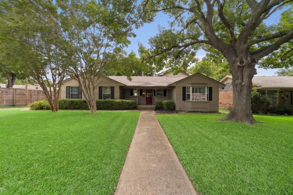 A quaint front porch on this Lake Highlands home practically invites rocking chairs, a slow cup of coffee, and a wave to neighbors out for an evening walk — the kind of everyday ritual that defines life in Dallas's storied L Streets. Set on a corner lot with a stunning mature oak tree, this traditional home, finished in classic brick and siding, carries the kind of original character that's increasingly hard to find, starting with the hardwood floors that run through much of the home and give it a warmth that newer construction simply can't replicate.

Inside, three bedrooms and two full baths are arranged across a layout made for both quiet living and lively gatherings. A separate living room and dining room give distinct purpose to everyday moments and special occasions alike, while the kitchen's built-in cabinetry and included refrigerator add a layer of thoughtful convenience. A standout 13-by-26 bonus room rounds out the floor plan, offering the flexibility to become a media room, home office, playroom, or whatever the next owner needs most.

Outside, an oversized attached two-car garage (21x20) offers room for vehicles, storage, or hobbies, and the backyard features a brick patio made for entertaining, relaxing with family, or simply enjoying an evening outdoors. Combined with the front porch and the corner lot's added breathing room, this home offers outdoor living at nearly every turn. All of this sits within the L Streets, one of Lake Highlands' most established and beloved pockets, known for its tree-canopied streets and close-knit community feel. Zoned for Richardson ISD just minutes from White Rock Lake, the Dallas Arboretum, and the shops and restaurants of Lakewood and Lake Highlands Town Center. Quick access to Central Expressway and LBJ Freeway keeps Uptown and Downtown Dallas comfortably within reach. Schedule a private showing today and experience the L Streets charm in person.