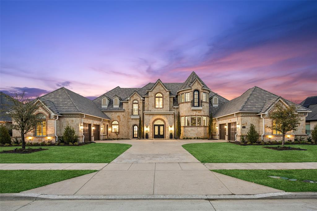 Tucked behind the guarded gates of The Hills of Kingswood — Frisco’s most elite private enclave — this French-country estate is a masterwork of craftsmanship, elegance, and enduring architectural style. Every element reflects intention and discernment: a turreted stone façade, slate-style roofline, and commanding double doors revealing travertine floors, soaring ceilings, and sunlight cascading through dramatic picture windows. At the heart of the home, the chef’s kitchen pairs a massive furniture-style island with KitchenAid professional appliances, custom cabinetry, and fluid connection to the main living room, where ornamental millwork and a stone-framed fireplace establish a mood of quiet luxury. A circular wet bar sits perfectly placed for entertaining, linking living, media, and outdoor spaces with effortless sophistication and natural flow. Two private guest suites reside on the main level alongside a true theater designed for elevated cinematic experiences. An executive study framed by bay windows and bespoke built-ins offers an inspiring backdrop for productivity and retreat. The primary suite stands alone — offering private garage entry, a fireside sitting area, direct yard access, dual couture-style closets, and a spa bath with freestanding tub and expansive walk-through shower. Upstairs, three ensuite bedrooms complement a large game room and balcony overlooking manicured grounds — ideal for a future pool, gardens, and outdoor kitchen oasis. And then, the showpiece: a rare, stone-clad grotto — a private sanctuary curated for wine tastings, speak-easy, or secure safe-room use. Minutes from PGA Frisco, Legacy West, and The Star — within premier Frisco ISD — this estate embodies privacy, presence, and an uncompromising standard of luxury reserved for the truly exceptional.