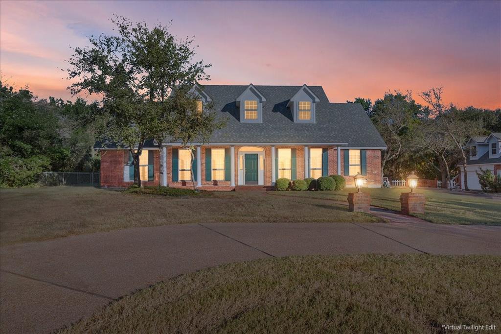 Imagine coming home to this beautiful red brick Southern Colonial Revival, sitting pretty on almost an acre and a half of wooded land so you'll have all the privacy you could ever want. From the moment you pull up, you'll feel that classic charm. The full-length front porch, complete with those graceful columns, the symmetry of the dormer windows upstairs - all add such character. Inside, you'll find a home designed for comfortable living. The main living space is wonderfully open, with the kitchen, living, and dining areas flowing seamlessly together – perfect for entertaining or just keeping an eye on things while you cook. If you need a dedicated workspace, you're in luck! There's a formal office with elegant French doors and built-in cabinetry, making it a quiet and productive retreat. The master suite is a true sanctuary. It's generously sized, and that huge closet? It even has a built-in safe for your peace of mind. The master bathroom is equally impressive, with a separate shower and a relaxing tub, plus two vanities, so everyone has their own space. An additional downstairs bedroom has its own full bath. Upstairs, you'll find a large area perfect for a media or game room, two more spacious bedrooms, and multiple storage areas – because who doesn't need more storage? The bedrooms share a Jack-and-Jill bathroom, a practical setup for family or guests. Now, let's talk about the garages, because this house really delivers there. You've got an oversized two-car attached garage, plus a detached two-car garage offering even more space, and above it, you'll discover a fantastic bonus room – perfect for a craft room, a home gym, or whatever hobby brings you joy. In addition, the property includes another 0.67 acres to the left of the home. This house truly has so much to offer, blending classic elegance with modern convenience, all wrapped up in a private, natural setting that’s not too far out of town - just two short miles up Gholson Road from Lake Shore Drive.
