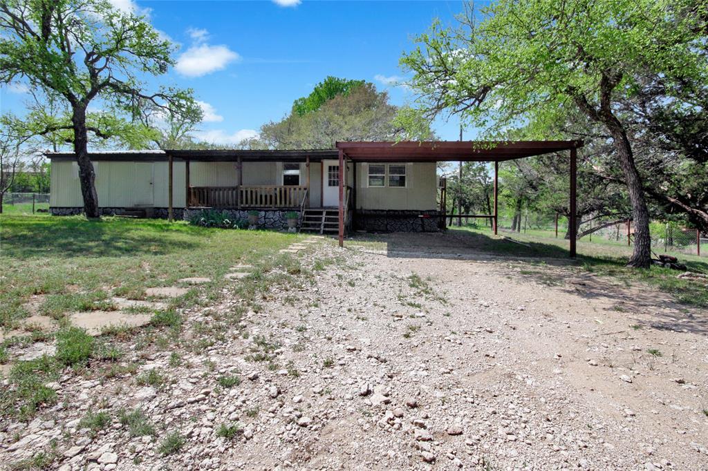 Discover serenity and convenience in this 2-bedroom, 1-bathroom singlewide mobile home on a spacious 0.93-acre lot in Western Lake
Estates. Located near the two private lakes with easy access to a boat launch. This home features a fully fenced yard, perfect for pets and outdoor activities, along with a chicken coop for hobby farmers. Enjoy the convenience of a 2-car carport and a spacious front porch deck, as well as the durability of a metal roof. The interior of the home could use a little TLC, but comes equipped with a refrigerator, washer and dryer. Ideal for first-time buyers, those looking to downsize, or anyone seeking a low-maintenance lifestyle with room to roam. Don’t miss this opportunity to own a cozy home on a fabulous lot!