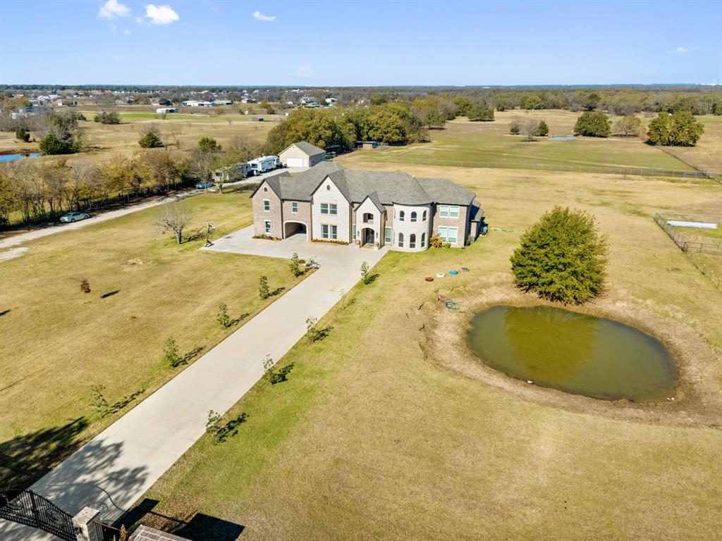 Exceptional Private Gated Multigenerational Home on 10.1 Acres, AG exempt in Royse City, Texas, total of 7,998sq ft of living space and offering privacy, and flexibility (outside city limits). The private gated entrance welcomes you into this expansive property designed for comfortable everyday living. The main residence spans an impressive 6,645 sq ft, featuring 6 bedrooms, 5 full bathrooms, and 2 half bathrooms, office, media room, dining room, 2 living rooms, 1 game room, open gym room and laundry room thoughtfully laid out to accommodate large or extended families. Interior highlights include quartz countertops, hand-scraped hardwood flooring throughout the home, custom built-in cabinetry in closet areas and throughout, 9ft ceilings in second floor, 10ft ceilings downstairs. In addition to the main home, the property includes two separate multigenerational residences, ideal for extended business use, guests, or private living quarters. Exterior features two Ponds, Metal 30x40 workshop, Fishing Boats, RV hookups and fully fenced in for all your horses, chickens and cattle. Set behind a private gate and surrounded by open acreage with AG Exempt and wide-open TEXAS skies, delivers peaceful country living with endless possibilities—yet remains just minutes from shopping, restaurants, and Lake Ray Hubbard, with quick access to major highways and located within the Royse City ISD. Come see for your self !