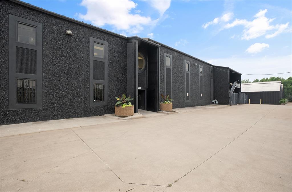 3500 Easy St is one of the most unique property offerings in Dallas, Delivering unmatched versatility just moments from the highly coveted Design District. Spread across just under one acre, the site includes two distinct buildings that together offer a rare blend of creative, residential and industrial space. The centerpiece is a striking stone and tilt-wall structure currently serving as a warehouse and design studio for one of Dallas’ most prominent designers. Above the studio, a spacious 3,200 SFT apartment features 4 bedrooms and 1 bathroom, perfect for on-site living, guest accommodations, or executive office use. Also on property is a massive 7,169 SFT metal building, used for storage and prop fabrication. This structure includes three stone-walled workshops and a dedicated stone-walled office space with a private bathroom, enhancing functionality for a variety of uses. Explore the endless possibilities that come with ownership of 3500 Easy St.