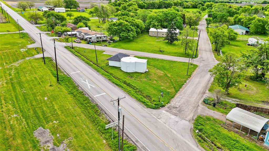This unique property, formerly home to the old water tower and water department office, offers a wealth of potential for a variety of uses. Previously classified as commercial, the property is situated on a prime corner with road frontage on three sides, ensuring excellent visibility and access.
The building itself has been completely renovated, featuring updated floors, fresh paint, a new roof, and appliances—ready for immediate use. Whether you're looking to create office space, retail, or even a residential development, the possibilities are wide open. The iconic old water tower, currently utilized for storage, adds an intriguing element with its potential for creative repurposing or further development. For those interested in a different vision for the property, a zoning change may be pursued with Collin County to accommodate various uses, allowing you to bring your ideas to life. Don't miss the opportunity to invest in a property with character, history, and endless potential! Come explore this distinctive property, ideally located in the heart of a rapidly growing community, just minutes from Lake Lavon, Rockwall, Wylie, and Farmersville.