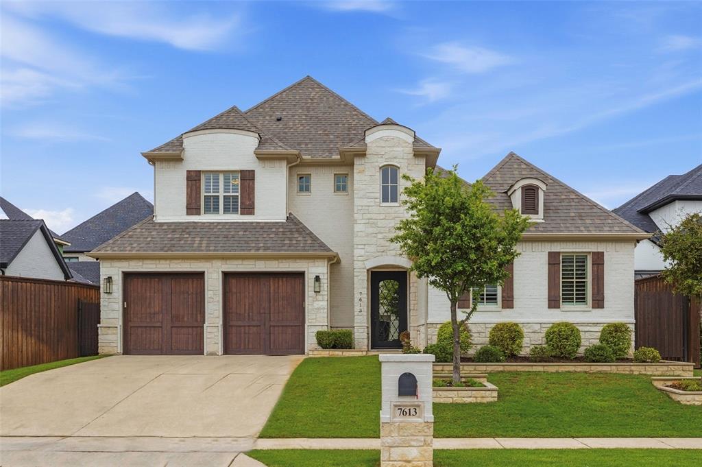 Exceptional custom-built home showcases timeless architecture, designer finishes, and an ideal layout designed for both everyday living and entertaining. The grand entry welcomes you with soaring ceilings, rich wood floors, and a striking staircase that sets the tone for the elegant interiors beyond. The light-filled living room features a floor-to-ceiling fireplace surround, custom built-ins, and seamless access to the expansive covered patio, creating an effortless indoor-outdoor lifestyle. At the heart of the home, the kitchen features an oversized quartz island, custom cabinetry extending to the ceiling, stainless steel appliances, double ovens, a gas cooktop, designer lighting, abundant prep space, and a walk-in pantry. The adjoining dining area is framed by large windows and a coffered ceiling, offering the perfect setting for gatherings both large and small. The private primary suite is a true retreat with a spa-inspired bath featuring dual vanities, a freestanding soaking tub, oversized walk-in shower, and generous custom closet space. A secondary bedroom and full bath are conveniently located downstairs, while upstairs offers two additional bedrooms, two baths, and a versatile loft ideal for a game room, media space, or second living area. Step outside to enjoy the expansive covered patio complete with an outdoor fireplace overlooking the beautifully maintained backyard. A beautifully appointed laundry room with extensive cabinetry and additional storage adds both style and functionality. The three-car tandem garage features epoxy flooring and a large walk-in storage closet.