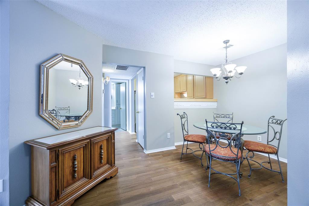 Whether you are looking for a sophisticated retreat or a functional home base near the city’s most prestigious amenities, this first-floor condo offers a lifestyle of effortless elegance. Community amenities include 2 relaxing pools right on the grounds.  As you step inside, the seamless flow of luxury vinyl plank flooring guides you through an open-concept layout designed for both comfort and style. The heart of the home is a cozy den, where a classic fireplace serves as the perfect centerpiece for quiet evenings or intimate gatherings. The primary suite is a true sanctuary. Here, you’ll find a spacious walk-in closet and sliding glass doors that bathe the room in natural light and offer direct access to your personal patio. The ensuite experience is elevated by a fully updated primary bath, featuring a contemporary, oversized shower that brings a spa-like feel to your morning routine. Flexibility is key in the second bedroom, a versatile space that easily transforms into a professional home study or a dedicated exercise room to suit your pace of life. Outside, the private patio provides a peaceful breath of fresh air, complete with an additional storage closet to keep your gear organized and out of sight. Perfectly positioned just moments away from lush parks, elite golf clubs, and top-tier private schools, this residence offers more than just a home - it offers a connection to the very best the community has to provide. This is first-floor living, refined with a convenient assigned covered parking space outside your door.