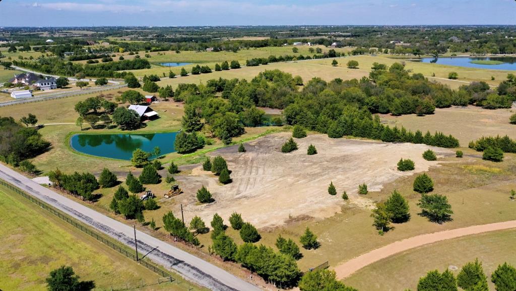 Located in the beautiful rolling countryside area of McDonald & Stevens Rd in South Rockwall Co (Rockwall ISD-Amy Parks, Cain, RHHS) among magnificent luxury acreage estates with sweeping views you'll want to come home to. This remarkable property is ready now, whether you envision a cozy comfortable cabin, a spacious luxury family home or even a Barndominium for the perfect week end get away, this property checks that box. No HOA & not located in the city limits (no city tax), Enjoy the serenity of rural living combined with ez access to shops, restaurants, & recreational activities. This special property also offers access to two private ponds, perfect for fishing away those peaceful afternoons or just relax in the shade & enjoy the peace & quiet.  The combination of rolling hills, stunning views, and access to water makes this property a true gem. Water Meter installed. 5 minutes out of Heath. Search the market, these opportunities are RARE.