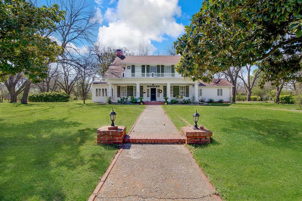 Welcome to this stunning 1930 corner-lot home, where timeless character meets thoughtful updates. Offering 3 bedrooms, 3 full bathrooms, and a detached 2-car garage with an attached workshop with electricity, this property delivers both charm and functionality.

Step inside to a grand staircase that immediately sets the tone. To the left, the formal living room features a wood-burning fireplace and French doors that open to a light-filled enclosed sunroom that's complete with operable windows for fresh air. Just beyond, a versatile flex space currently serves as a breakfast area but easily functions as a home office or study.

To the right of the entry, the formal dining room showcases beautiful built-in cabinetry and shelving, along with a second wood-burning fireplace. The dining space flows seamlessly into the fully renovated kitchen, featuring custom cabinetry, updated appliances, a walk-in pantry with saloon doors, and generous counter space.

Just off the dining area, the main living space is filled with natural light and offers built-ins plus an attached full bath,  giving it the potential to be utilized as a second primary suite, guest quarters, or media room.

Upstairs, the primary suite includes ample closet space and a private ensuite bath. Two additional bedrooms are thoughtfully separated, each with great closet storage. One bedroom features its own updated ensuite with a vanity area and a large soaking tub.

Outside, enjoy a pergola-covered outdoor living space, perfect for relaxing or entertaining, along with the detached garage and workshop.

This is the kind of home you don’t come across often; full of original character, but updated where it counts.