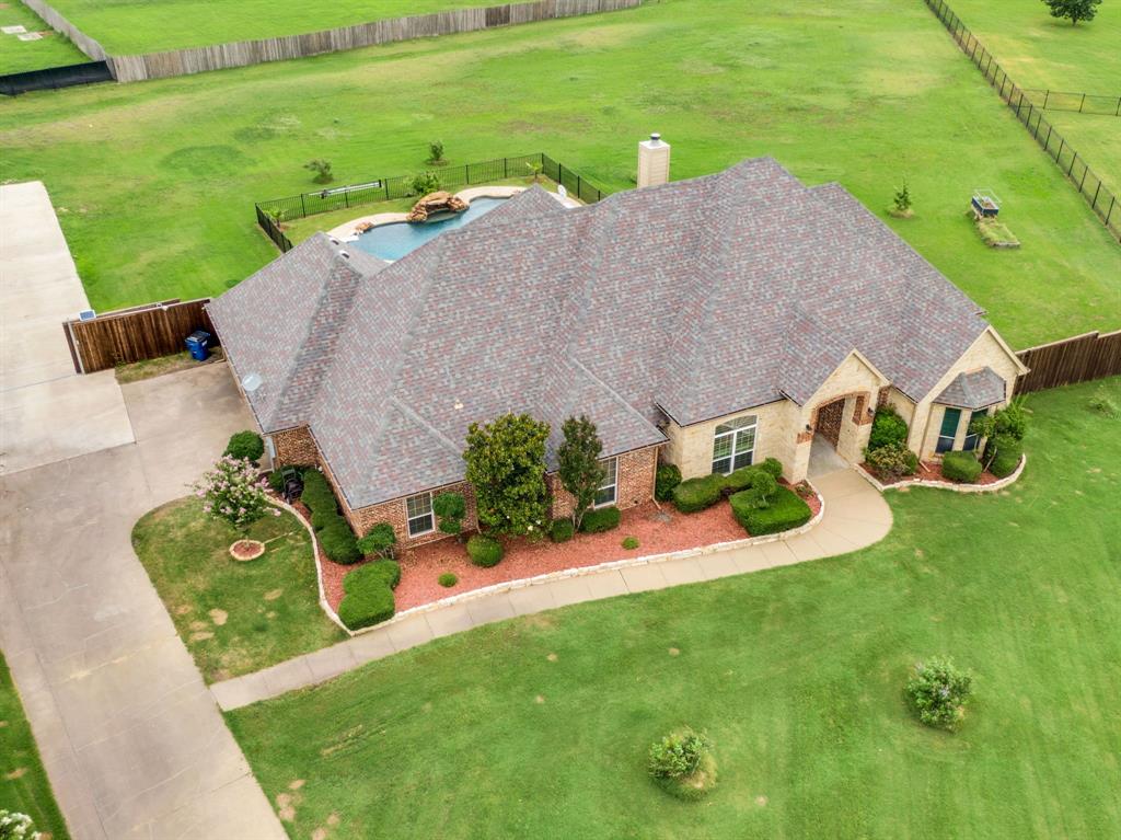 Gated Community Living At Your Finger Tips! Located in one of Forney's most sought after gated communities, 3133 Belmont offers all you need PLUS more! Natural light flows into the first floor of the home from the large windows flanking the stone fireplace, offering an unobstructed view of the backyard and pool. The views of the backyard continue into the kitchen, where the stained cabinets and granite countertops add warmth to the space! In the primary suite, coffered ceilings and bay windows create a luxe feel.

This thoughtfully designed 4 bedroom, 3 bath home offers plenty of space for both everyday living and entertaining. The spacious living areas flow seamlessly into the outdoor retreat, featuring a beautiful pool and an extended back patio with a custom pergola. The perfect setup for relaxing evenings or hosting family and friends.

The backyard continues to impress with an additional concrete pad designed for RV or boat parking, providing the flexibility and convenience that is hard to find. The massive 3-car garage offers ample room for vehicles, storage, hobbies, and all of life's extras.

Located in a secure gated community and a prime Forney location, this home combines comfort, functionality, and elevated living. Don’t miss the opportunity to make 3133 Belmont your next home!