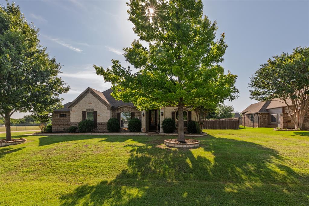 Look what awaits you in this beautiful home located in Haslet.  Pool, covered patio with television, outdoor kitchen, fire pit, large pool and over half an acre of land, fully fenced.  Sounds like the perfect place to relax all year round. This home has four bedrooms, three full bathrooms and a half bath.  In the heart of the home, you'll find ample room for cooking in the large kitchen, along with a breakfast room, vaulted ceiling in the family room and a fireplace.  Perfect for entertaining!  The primary bedroom is located at the back of the home off the family room. It is a large space with large ensuite bath. Near the primary is a large utility room with lots of storage.  Downstairs you will also find a study with French doors off the entry and two other bedrooms with their own bath.  The upstairs bedroom has built in roomy bunkbeds and a bathroom of its on. If you're in need of storage there is a large, floored attic and separate storage room accessed from the driveway next to the three car garage with epoxy flooring.  There is also a shed located in the backyard for all your pool items.  The owners built the home in 2013 and have been the only occupants. Come see this home in person to appreciate all of its great features.