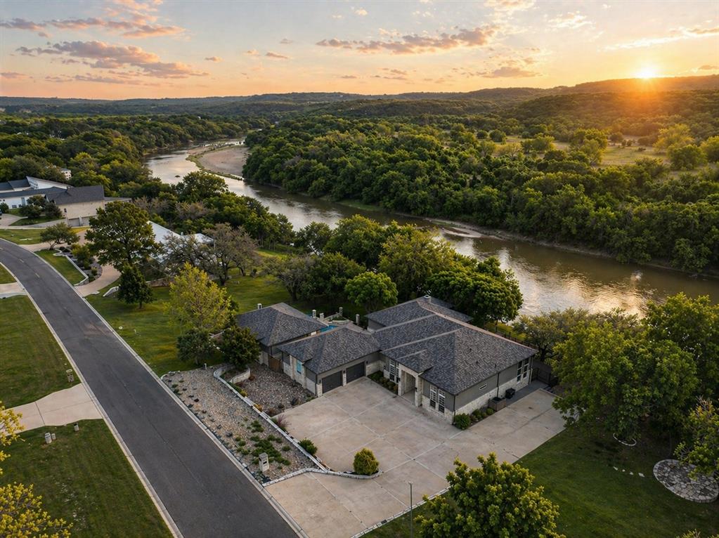 Set within the prestigious gated enclave of Pecan Plantation, this refined 4-bedroom, 3.5-bath residence blends timeless elegance with serene natural beauty, privately positioned along a sweeping bend of the Brazos River with expansive views and stunning sunset backdrops, and complemented by exceptional amenities including championship golf, a private marina, equestrian facilities, dual private airstrips, private dining, and an elegant clubhouse.The expansive grounds are designed for both leisure and entertaining, featuring a sparkling pool, elevated deck, outdoor kitchen, and inviting front and rear porches that create seamless indoor-outdoor living. A sun-drenched sunroom frames sweeping river views, offering a peaceful retreat in every season. Inside, a grand entry opens to an expansive, light-filled interior where rich hardwood floors and a statement fireplace anchor the space with warmth and sophistication. The U-shaped kitchen is designed for both style and function, offering generous workspace and a layout that supports seamless entertaining. The primary suite is thoughtfully designed with a dedicated sitting area, a well-appointed ensuite bath, and generous walk-in robe. A wall of windows captures sweeping Brazos River views, with a winding staircase leading down to the deck. Additional bedrooms are generously proportioned and elegantly finished, offering both comfort and ample storage.
This is a rare opportunity to own a premier riverfront residence within Pecan Plantation. There is no substitute for the right address, an opportunity not to be missed.