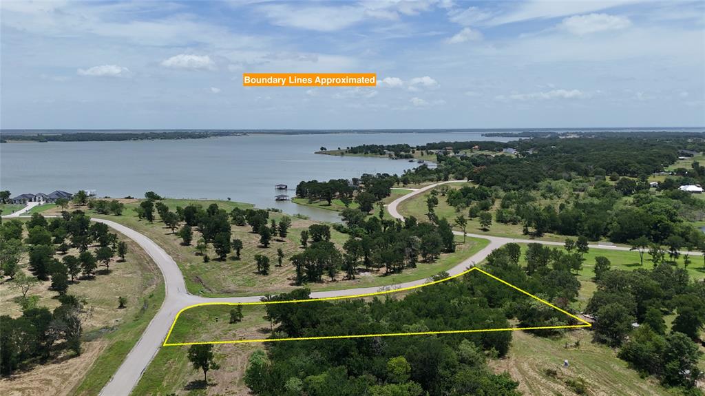 Lot 6 is a gem of an off water lot in Diamond Point on Richland Chambers Lake. Located on a corner, you'll have 472 ft of road frontage, so plenty of room to decide where to build your new lake home. This lot has been cleared along the road frontage,  but is still heavily treed at the back so you can choose what to remove or leave based on your own needs! Worried about how to get out and enjoy the lake if this lot is not water front? Don't! Lot 6 includes a boat slip #23 in the gated Diamond Point marina. It doesn't get any easier than that! All the fun without the upkeep and maintaining a waterfront property! Diamond Point is a fast developing gated community and restricts to site built homes with a minimum square footage of 1,400 to 1,800 to maintain the integrity of the subdivision. Best of all, you are just a minute away from Richland Chambers Lake...known for its superb fishing! So grab those house plans & come take a look!