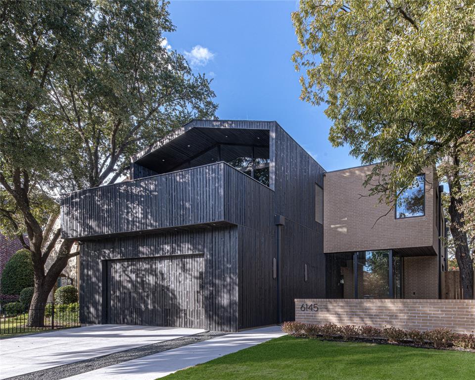 Luxury modern residence meticulously built by Thurmond Design + Build, showcasing refined architectural restraint and exceptional material execution throughout. A gallery-like main level is anchored by a sculptural stone fireplace and custom millwork, flowing seamlessly into a chef’s kitchen featuring full-height custom cabinetry, statement natural stone surfaces, and integrated storage designed for both daily living and elevated entertaining. Expansive glass walls connect the interior to a covered outdoor living space, creating effortless indoor–outdoor flow year-round. The primary suite offers a private retreat with spa-inspired limestone and travertine bath, oversized wet room, and a generous walk-in closet with custom millwork, integrated lighting, center island, and complete with washer-dryer hookups. Upstairs, additional four bedrooms each include private baths and thoughtfully designed custom closets with integrated lighting. Two flex spaces with outdoor patios allow for a home office, media room, or gym. Outdoor areas are intentionally left open-ended, providing the opportunity to tailor the backyard and covered living spaces to a buyer’s vision—whether a custom pool, turf lawn, or bespoke outdoor kitchen. Infrastructure and access are thoughtfully planned to support multiple configurations without compromise. Located just steps from Tietze Park and minutes from Lakewood and Lower Greenville, this residence balances architectural clarity, material integrity, and livable luxury in one of Dallas’ most sought-after neighborhoods.