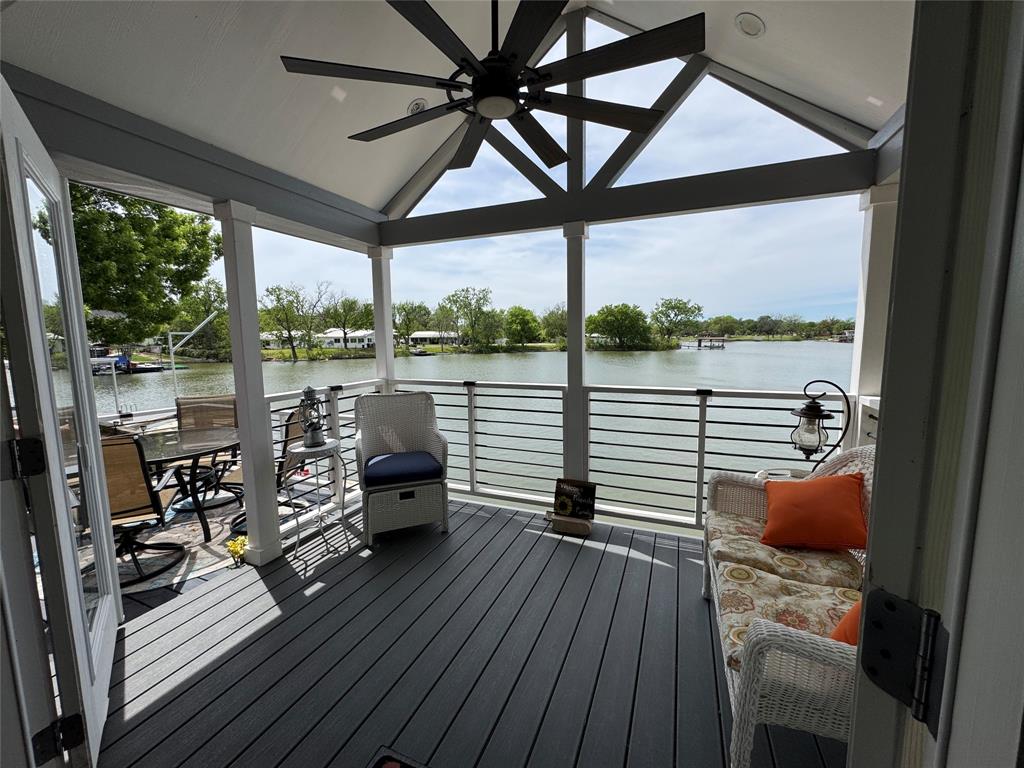 Have you ever wondered what a true tiny home feels like in a stunning lakefront setting? Opportunities like this are incredibly rare—especially on Lake Granbury.
Situated on an oversized lot, this property offers room to expand and endless possibilities. Ideal as a full-time residence, weekend retreat, or investment property.
Inside features a custom designed layout with a main-floor bedroom, full kitchen, bathroom, and washer-dryer. Upstairs, a cozy 10x10 loft includes a king-size bed, TV, and seating area with approximately 4-foot ceilings—perfect for relaxing while enjoying peaceful lake views.
Step outside to the expansive wraparound deck—ideal for morning coffee or evening wine with friends while taking in breathtaking sunsets across the water. Love to fish? Cast a line right from your porch.
Enjoy direct access to Lake Granbury via the community boat ramp, providing easy entry to the main body of the lake. Even better, the property is already approved by the Brazos River Authority for the addition of a private boat dock—an incredible future value.
Built just 2 years ago, this high-end Platinum tiny home—crafted in Malakoff, TX—features over $20K in upgrades, two mini-split systems, and fully self-contained, efficient living. Utilities are typically under $130 per month.

Additional features include:
• Double carport
• Built-in storage shed
• Space for a golf cart
• Guest parking
• Quiet cul-de-sac setting

Enjoy affordable lakeside living with property taxes around $1,300 yearly (with senior homestead exemption) and HOA of just $259 yearly. Rentals allowed (6-month minimum).
Conveniently located 35 minutes to Fort Worth and 60 minutes to DFW International Airport. Just minutes from shopping, dining, and the charm of the Historic Granbury Square.
Lakeside living at its best—peaceful, affordable, and full of charm.