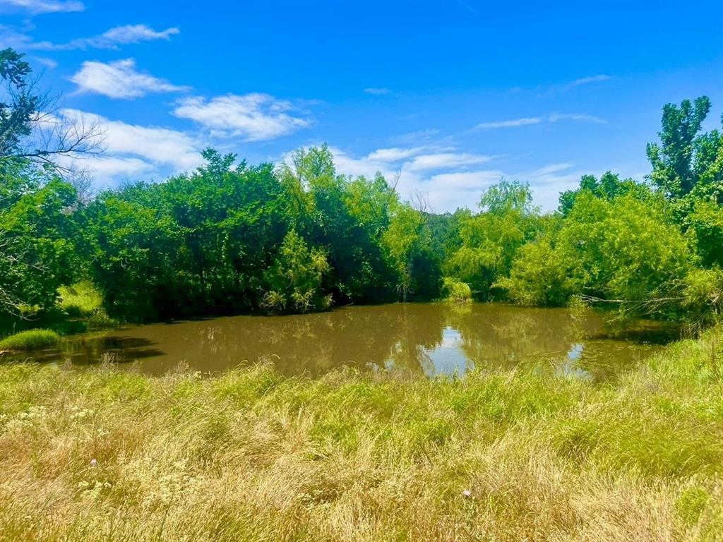 Lot 99 is tucked away in the peaceful and scenic community of Sarra Ranch Estates, offering the perfect setting to plant your roots in sought-after Parker County. Conveniently located just approximately 12 minutes north of the Weatherford courthouse, this exceptional property combines the serenity of country living with easy access to town amenities.
As one of only two tracts in the community featuring a pond, Lot 99 is truly a rare find. The property is accented by several clusters of mature oak trees and offers multiple ideal building sites, each perfectly positioned to take in breathtaking sunrises and sunsets across the Texas landscape.
Sarra Ranch Estates features 103 lots arranged within a private loop, creating a safe and inviting environment for morning jogs, evening strolls, or horseback rides throughout the neighborhood. Here, you’ll enjoy the charm of country living while becoming part of a welcoming community where lasting friendships are easily made.
Come discover the lifestyle Sarra Ranch Estates has to offer — welcome home.