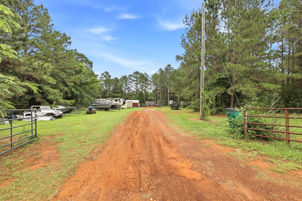 Welcome to 6194 FM 19 in Neches, Texas; a rare opportunity offering nearly 3 acres of endless possibilities in the highly sought-after Neches ISD. Tucked away among mature trees for natural privacy and seclusion, this property offers the peaceful country lifestyle while still being just minutes from everyday conveniences and River Run ATV Park. The 3-bedroom, 2-bath home features a spacious layout with a large primary suite complete with an ensuite bathroom and walk-through closet. The additional bedrooms provide flexibility, with the third bedroom being large enough to easily serve as a shared space if desired. All appliances convey with the home, making this property move-in ready from day one. Outside is where the potential truly shines featuring THREE separate RV spots, each equipped with its own septic system and water supply, with electricity available for connection at each site. Whether you envision multi-family living, guest accommodations, rental income potential, or the ultimate recreational retreat, the setup is already in place. If you’ve been searching for privacy, versatility, and room to grow, this one checks every box.