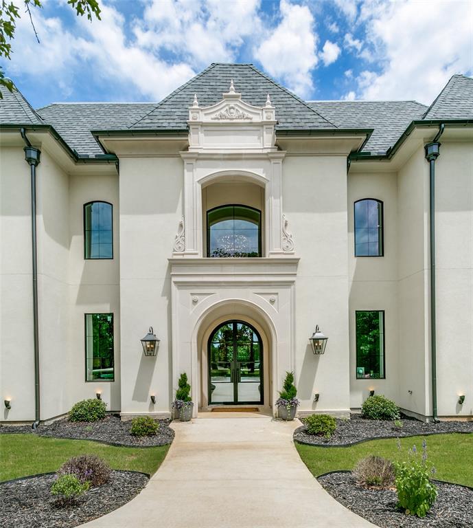 This stunning French-inspired custom estate seamlessly blends timeless elegance with luxurious modern design. From the magnificent iron entry doors to the dramatic double staircase, every detail has been thoughtfully curated to impress. Step inside to soaring 24-foot ceilings and an expansive open-concept layout highlighted by premier designer lighting valued at over $100,000, rich hardwood flooring, cathedral ceilings, and striking wood beams. Floor-to-ceiling windows flood the home with natural light while showcasing the breathtaking backyard retreat. The grand 24-foot fireplace creates a dramatic focal point, complemented by elegant interior balconies overlooking the main living space.
Designed for both entertaining and everyday luxury, the chef’s kitchen features custom cabinetry, marble countertops, an oversized island, two-tone ZLINE designer appliances, an eight-burner gas range, and a spacious baker’s pantry complete with an additional oven.
Privately tucked away, the luxurious primary suite offers double-door entry, soaring ceilings, and a cozy fireplace. The spa-inspired bath boasts dual vanities with marble countertops, elegant chandeliers, a soaking tub, and a separate oversized shower.
Upstairs, the second level includes two spacious bedrooms, two full baths, and an incredible two-story playroom. The third floor offers an approximately 1,200-square-foot flex space featuring a one-of-a-kind slide connecting to the second floor — perfect for recreation, entertainment, or creative living. Situated on a premium 0.73-acre corner lot, the outdoor living area is equally impressive with a covered patio and outdoor fireplace ideal for year-round enjoyment. Additional features include a three-car garage, full spray foam encapsulation, pre-wiring for sound and media, sprinkler system, and access to highly acclaimed Keller Independent School District schools.