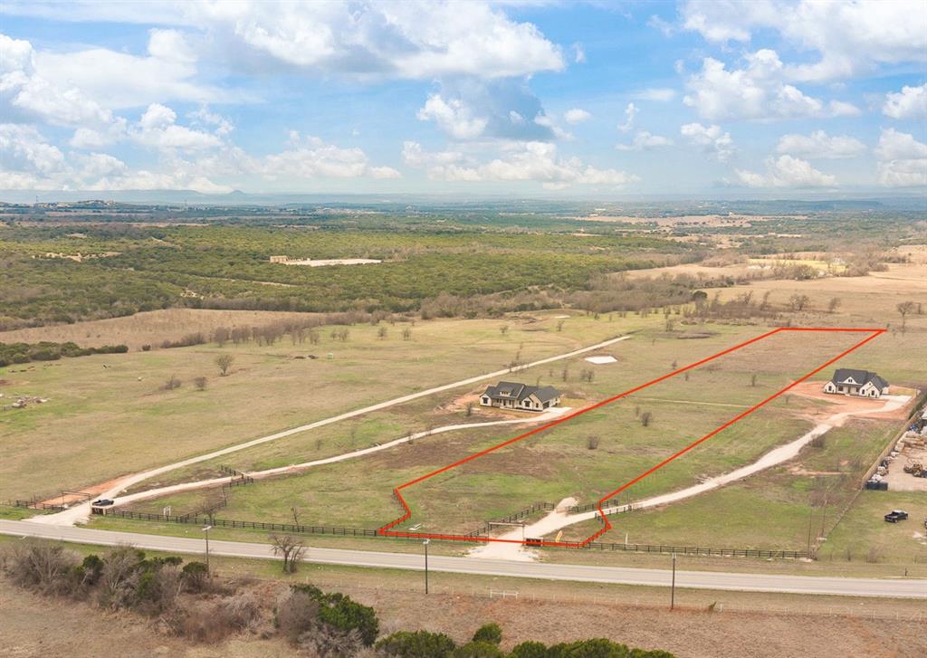 Beautiful 5.697 acre build ready homesite in the new Vista Ranch acreage subdivision, located in highly sought-after Godley ISD. Lot 2 offers the perfect combination of peaceful country living and convenient access to nearby amenities.  Property improvements already in place include underground electric service, front fencing, an attractive overhead entry, and a private gated entrance, saving time and expense when you're ready to build. Bring your horses and livestock and enjoy the freedom of country living with no HOA. Deed restrictions help protect property values while maintaining the area's rural charm.  Build your custom dream home, modify one of our available floor plans, bring your own builder, or hold as an investment with no required timeframe to build.  Conveniently located just 5 miles from Acton, 9 miles from Godley, and 12 miles from Granbury. Shopping, dining, Lake Granbury public access, and recreation are all nearby. Easy access to the Chisholm Trail Parkway and the DFW Metroplex, with DFW Airport approximately 67 miles away.  If you're looking for room to roam, a homestead lifestyle, and a property that's ready for your vision, Vista Ranch delivers the best of country living with modern convenience.
