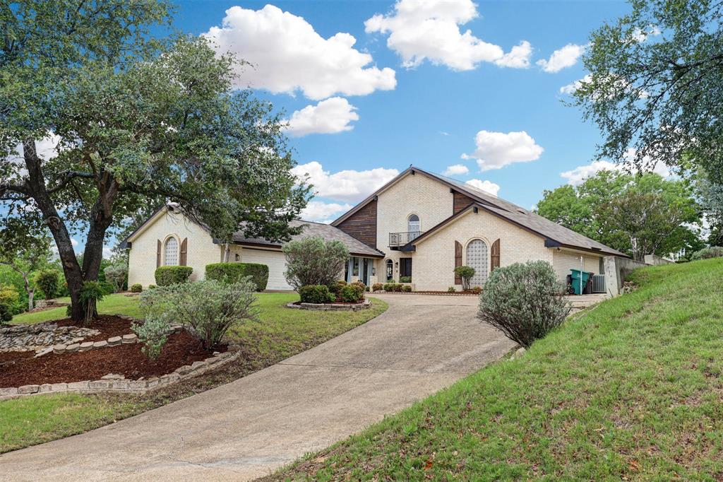 Tucked into the scenic Lake Country Estates community, this spacious 4-bedroom, 3-bath home blends comfort with distinctive architectural character. From the moment you enter, you’ll notice the unique charm created by graceful arched openings and thoughtfully designed lines that give the home warmth and personality. The inviting living area is anchored by a striking brick fireplace, creating a cozy yet stylish focal point for gathering and relaxing.

Filled with natural light, the home offers a functional layout ideal for both everyday living and entertaining. The kitchen features double ovens, generous cabinetry, and ample prep space to accommodate everything from weeknight meals to hosting guests. The private primary suite serves as a peaceful retreat with multiple closets and a well-appointed ensuite bath.

Step outside to a large covered patio overlooking the expansive backyard—perfect for enjoying quiet evenings or taking in the beautiful Texas sunsets.  Located near Eagle Mountain Lake and zoned to Eagle Mountain-Saginaw ISD, this home offers a wonderful balance of peaceful living with convenient access to shopping, dining, and city amenities.