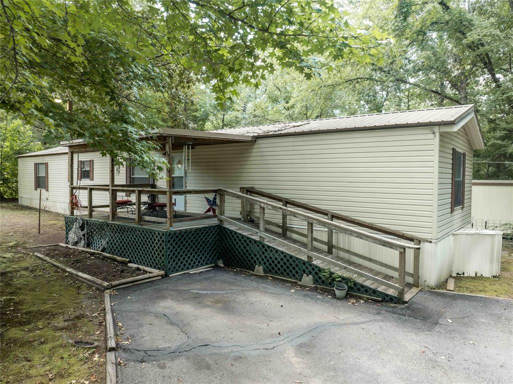 Very nice well maintained 1991 single wide mobile home located on 3 lots totaling 0.592 acres in the gated community of Hickory Hills.  This 3 BR, 2 bath homes comes with 4 storage buildings with over 800 sq. feet of storage space.  Back yard includes a fire pit area and the home has a large 10x16 front porch and a large back deck of 18x20.  One of the storage buildings takes up part of that deck space and would be a great workshop or great craft room or games room at 12x14 feet.  This home is a very short walk to the water and the swim and fishing area.  The gated community of Hickory Hills is located on the 365 acre spring fed Callender Lake that has great fishing, swimming, and boating.  The community has a pool, fishing pier, boat ramp, children's park, basketball court, restroom and shower facility near the pool and so much more for your enjoyment.  Contact your realtor and come see this great home today.  It is time to start enjoying the LAKE LIFE!!!
