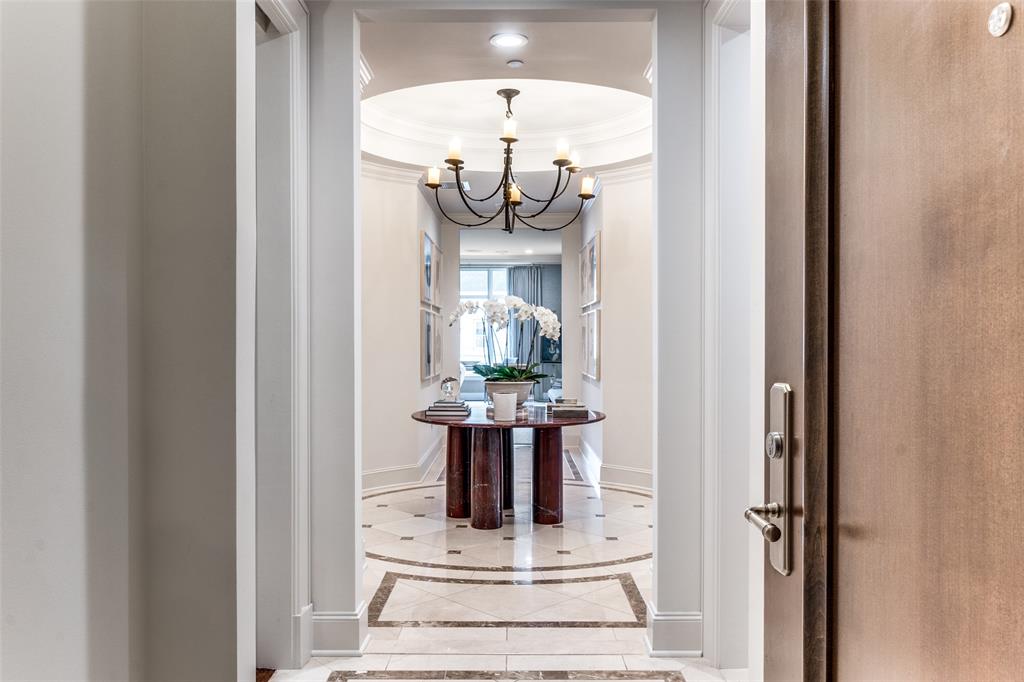 Welcome to the  Ritz, like no other, this custom unit offers an elegant entry that leads to a breathtaking great room with panoramic city views. With spacious living in mind this floor-plan is perfect for entertaining on a grand scale. The chef's kitchen is a dream, featuring an oversized island, high-end Wolf and SubZero appliances. The primary suite is large and truly impressive, with a closet that is the center of all envy at the Ritz.  A private screening lounge  completes the spacious design home, making it the epitome of luxury and style. The Ritz Carlton is renowned for its 5-star service and offers an upscale, maintenance-free lifestyle. Residents can enjoy concierge services, room service, valet, a spa, fitness center, and pool. Located in the vibrant Uptown neighborhood, this property is within walking distance to The Crescent, Klyde Warren Park, CBD, Victory Park, American Airlines Center, and a variety of excellent shopping and dining options