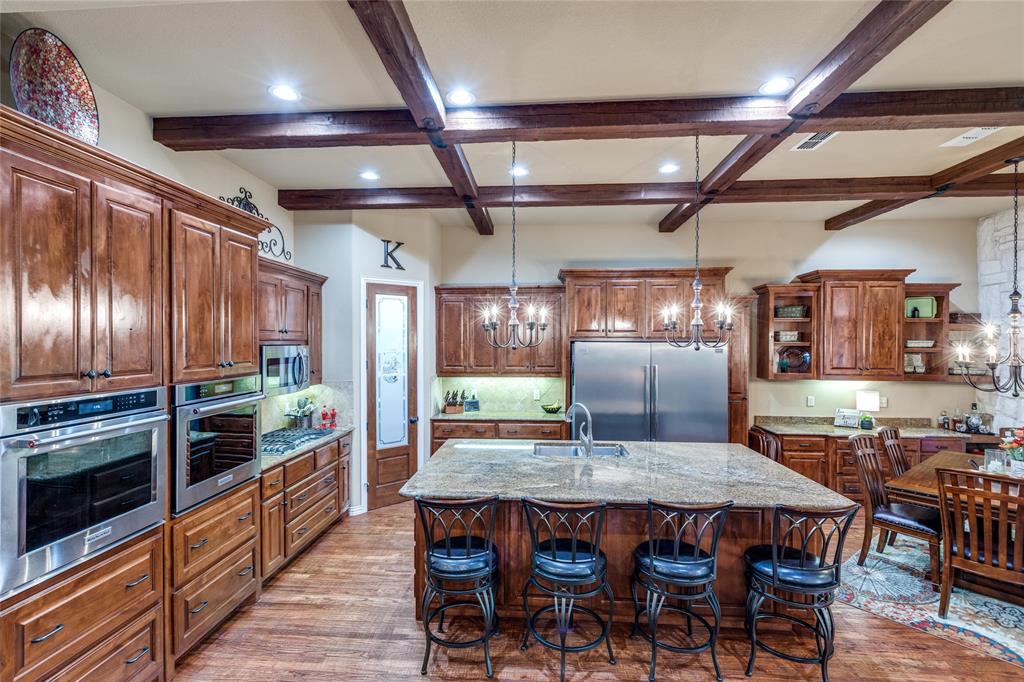 Huge Price Drop! The owner is motivated. Welcome to this stunning custom-built home by Cashion Custom Homes! Nestled on a private lot with an unbuildable lot next door, this property offers exceptional privacy and a beautifully treed backyard—an ideal oasis for relaxing evenings.

Inside, you’ll find 4 spacious bedrooms, 3.5 baths, a dedicated study, and a formal dining room. Thoughtful upgrades are showcased throughout, including custom built-ins, rich hand-scraped hardwood floors, striking wood beams, and elegant stone accents. The office is perfectly designed for crafting or working from home, while abundant storage ensures everything has its place.

The garage includes a golf cart bay with its own door and an in-ground storm shelter for peace of mind. In 2024, a whole-home Generac generator and an additional storage closet were added for extra convenience.

As an added bonus, the living room TV and kitchen refrigerator freezer will stay with the home. This really is a beautifully upgraded, move-in-ready retreat! See docs for full list of upgrades