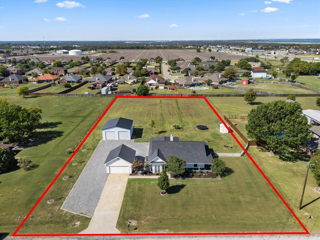 Welcome to this picture-perfect updated farmhouse retreat on 1.3 acres in Lavon, just minutes from scenic Lake Lavon! This inviting 3-bedroom, 2-bath home captures classic country charm with its wrap-around porch and welcoming curb appeal. Step inside to discover a warm, open layout filled with natural light and thoughtful details that make every space feel like home. Enjoy peaceful mornings on the covered back porch overlooking your private acreage—complete with a chicken coop generator and plenty of room to garden, play, or simply unwind. A recently added shop with pull through door, adds incredible versatility for hobbies, storage, or creative projects. Don't miss the extra room for parking!  Whether you’re dreaming of a little homestead or a quiet place to relax close to the lake, this property delivers the best of both worlds. Homes like this are rare—come see it in person and fall in love with the lifestyle it offers!  Check out the virtual tour and floorplan video too!