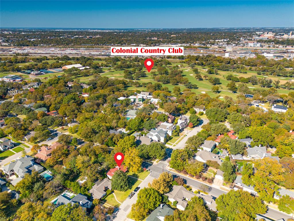 Charming Austin limestone home on a corner lot in the heart of the TCU, Colonial area, surrounded by mature trees and green space with minimal concrete and a true neighborhood feel. The striking exterior, with its red roof and blue front door, sets the tone for a home full of character, natural light, and thoughtful design. Inside, the layout offers spacious common living areas with private rooms positioned on either side, creating a functional and comfortable flow. Large windows throughout the home provide abundant natural light and views from nearly every room, with a standout wall of windows in the sunroom and secondary living space. The living area is anchored by a beautiful freestanding limestone gas fireplace, creating a warm yet open environment. The kitchen is efficient and well-designed with ample storage, multiple prep areas, and a corner sink overlooking the neighborhood. Outdoor living is a highlight, featuring three separate sitting areas including a front porch, elevated back deck, and lower patio, all offering unique views and a seamless connection to the surrounding greenery. The backyard provides a rare balance of privacy and openness, ideal for both relaxing and entertaining.  Additional features include a side driveway with turnaround access onto Park Hill, under-home storage, and a yard well-suited for pets and outdoor enjoyment. Located just minutes from TCU and Colonial Country Club, this home offers a vibrant yet peaceful setting with convenient access and strong neighborhood appeal.