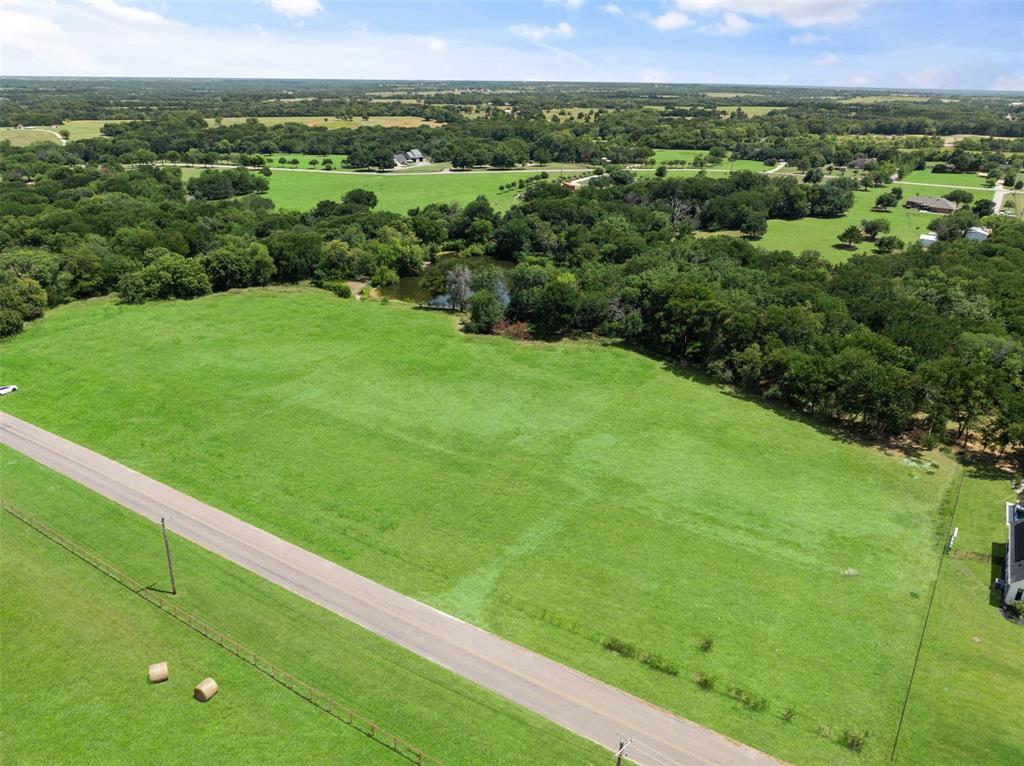 Excellent opportunity to own land with a pond in Celina! Don’t miss this rare chance to own a 2.2-acre lot in a prime location just minutes from downtown Celina with easy access to Custer Road, Preston Road and the Tollway. This beautiful property features a serene pond and mature trees along the rear lot line, offering the perfect blend of nature and privacy. Build your custom dream home with no HOA restrictions and enjoy the freedom of living outside city limits—no city taxes! Located within the highly acclaimed Celina ISD, this property combines peace, privacy, and accessibility. Must build with Melton Custom Homes per the deed restrictions. Buyer has two years to start construction. This lot offers tremendous potential in one of North Texas’s fastest-growing areas.