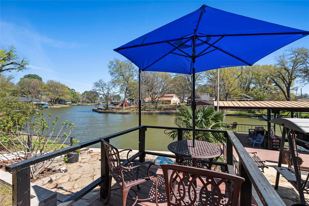 Waterfront three-level residence on Cedar Creek Lake featuring 175 feet of shoreline and open water views. The interior offers an open-concept kitchen, dining, and living area with vaulted ceilings and a chef’s kitchen equipped with double ovens. The floor plan includes five bedrooms and four bathrooms, with a primary suite located on the first level. Additional interior spaces include a flexible loft area, an art studio, and a workshop. The exterior grounds feature multiple entertainment areas, a firepit, and a landscaped paved courtyard. Parking includes a four-car garage and covered parking spaces. Many of the furnishings to remain with accepted offer.