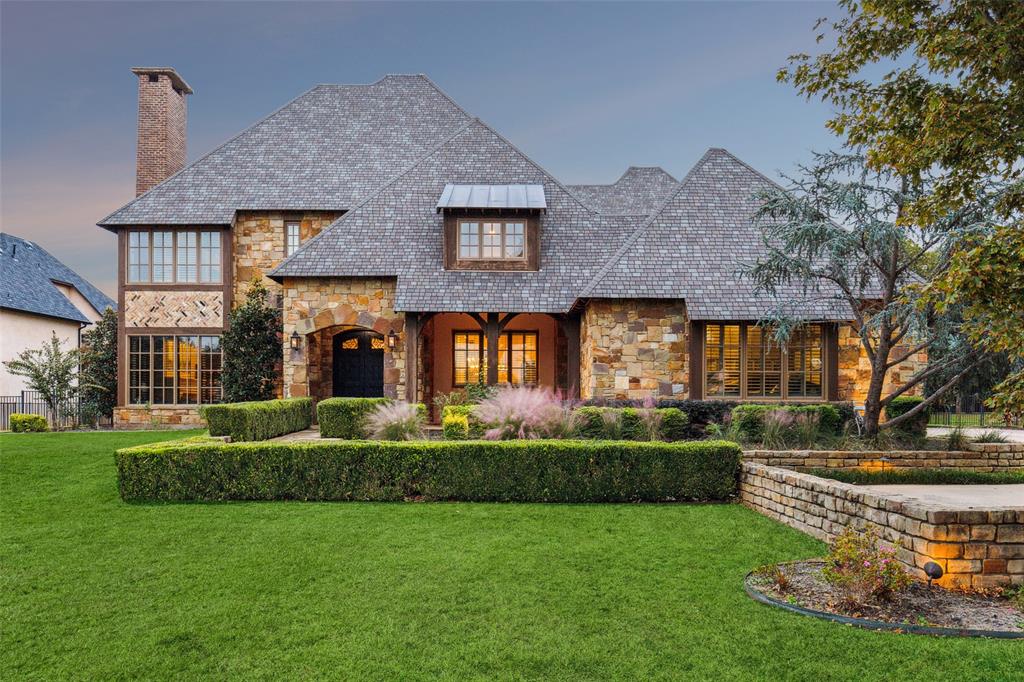 This breathtaking estate offers an unparalleled lifestyle, nestled on a beautifully landscaped 1 acre lot within the peaceful Chimney Rock Nature Conservancy and backing to a serene greenbelt. From the moment you arrive, the impressive curb appeal, w-an elongated driveway & three separate one-car garages, sets the tone for this exceptional home. Inside, an executive study awaits, complete w-a striking fireplace, custom built-ins & coffered ceilings—perfect for both work & relaxation. The open, airy floor plan features a formal dining room w-a wet bar, leading into the grand living room. This show-stopping space boasts wood-beamed ceilings, seamless windows w-views of the backyard oasis + a dramatic stone fireplace that creates a warm, inviting atmosphere. Gourmet kitchen is a chef's delight, featuring an expansive island, built-in refrigerator, dual sinks, dual ovens, a cozy breakfast nook & a full butler’s pantry. A spacious utility room w-a sink and built-in cabinets adds extra functionality to this well-thought-out layout. On the main floor, a private guest suite with a full bath (currently used as an exercise room) provides flexibility for guests or hobbies. The luxurious primary suite is a true retreat, with a comfortable sitting area and a spa-inspired bathroom complete with dual vessel sinks, a jetted tub, a walk-in shower + a custom closet. Upstairs, enjoy a media room with a wet bar, a game room, and three additional guest bedrooms, each with its own en-suite bathroom and large walk-in closets for comfort and privacy. The backyard is an entertainer’s paradise, backing to a greenbelt for added tranquility. A covered patio with an outdoor fireplace invites year-round enjoyment, while a gorgeous heated pool and spa offers the perfect escape during Texas summers. Nestled among the trees, a charming playset completes this private outdoor haven. This luxurious estate is designed for both elegance and comfort—ready to welcome you home!