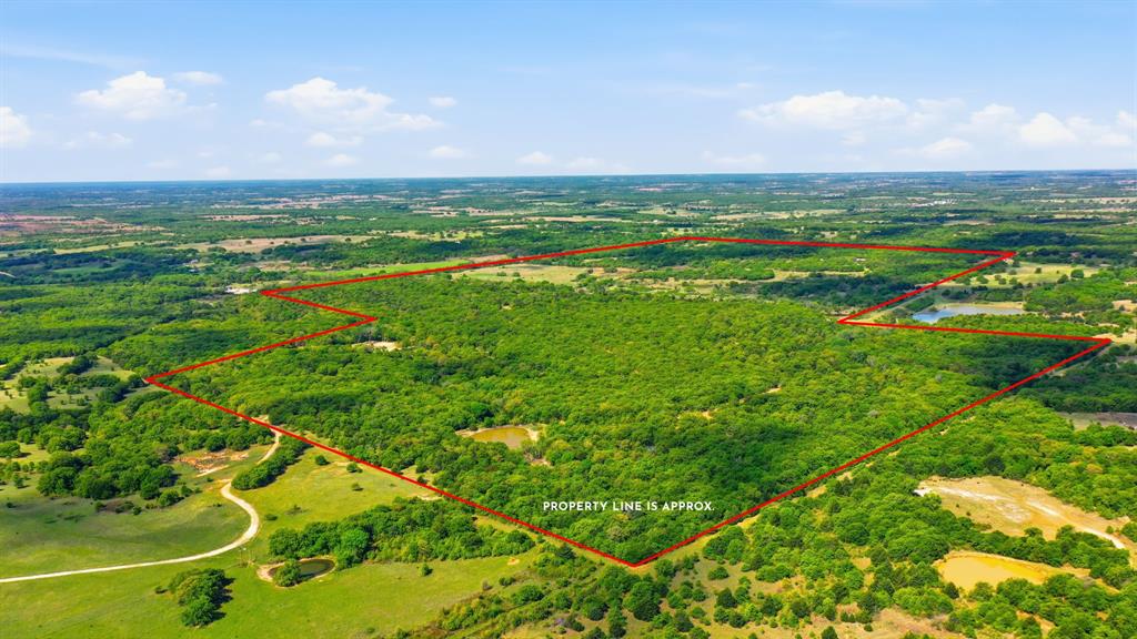 377+ Acre Premier North Texas Recreational & Hunting Retreat Welcome to an exceptional 377+ acre legacy property in the rolling hills of Montague County where rugged natural beauty meets thoughtful, turnkey improvements. With over 200 feet of elevation change, this ranch offers a rare combination of panoramic views, dense hardwood cover, and open pastureland ideal for both recreation and wildlife management. Designed with the avid outdoorsman in mind, the property is a fully equipped hunting and shooting retreat featuring an established skeet shooting range and a dedicated rifle range. The land supports abundant native wildlife, creating an outstanding environment for year-round recreation. The ranch is equally impressive in its improvements, offering four residences totaling over 7,000 square feet of living space. The main home is well appointed for comfort and entertaining, featuring a 6 burner gas range, dual dishwashers, tankless water heaters, wireless televisions, and expansive covered front and back porches that capture the surrounding views. A wood-burning stove and Cowboy Cauldron firepit create inviting gathering spaces for cool Texas evenings. Additional accommodations include a recently renovated casita and a log cabin with a new roof perfect for guests, family, or ranch staff. A 3,600 square foot metal barn provides ample storage for equipment, ATVs, and ranch operations. Water is abundant with two wells and five large ponds, supporting both livestock and wildlife. Infrastructure has been carefully considered with a 20KW Generac backup generator, whole-house reverse osmosis water filtration system, and reliable connectivity via Nextlink internet with Starlink backup. Safety and security features include a Class 5 above-ground tornado shelter, a dedicated gun room, and a secure safe. Rare opportunity to own a fully improved recreational ranch that seamlessly blends comfort, functionality, and natural beauty just a short drive from the DFW Metroplex.