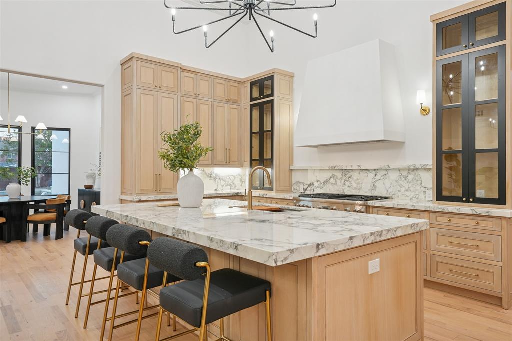There is a distinction between a residence built for the market and one designed for living. 

Set behind the gates of the exclusive Hills of Kingswood, 2095 Courtland Drive is the work of a resident designer who approached the 5,800-square-foot estate as a personal passion project — refining, layering, editing until the custom architecture met a moody, transitional aesthetic that felt fresh, yet soulful.

The stucco French Tudor façade makes no apologies — crisp, substantial, a deliberate rejection of the area’s prevailing glass-and-white minimalism. Inside, a groin vault entryway sets the tone: arched, detailed, quietly luxurious. White wood floors anchor expansive light filled rooms, the study dressed in the dramatic depth of Benjamin Moore's *Cheating Heart* while classic stones bring enduring patina to baths and surfaces.

The floor plan itself is a rarity. 5 bedrooms include three first-floor suites — dual primary retreats, and a sophisticated study — offering flexibility that defies convention in this price category. Dual kitchens outfitted with professional Thermador and Bosch appliances handle both everyday living and large-scale entertaining. In the media room, sliding glass doors, open to a 0.58 acre mansion lot with a resort-caliber pool and grounds scaled for gathering.

With a brand-new roof and amenities that rival homes at $5M+, this is what designer ownership delivers: character, provenance, and the kind of uncompromising attention to detail that only happens when every choice feels personal. Steps from Frisco’s vibrant shopping and dining, zoned for top rated schools, set in the city’s most prestigious guard gated neighborhood.