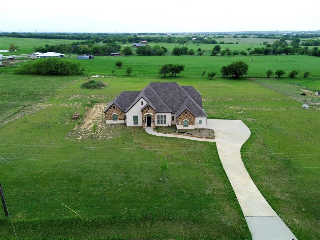 WELCOME TO 9517 INDIAN TRAIL, SANGER, TEXAS, LOCATED IN THE SOUGHT-AFTER CLARK RIDGE ADDITION*THIS MODERN DESIGNED HOME IS SITUATED ON A 2.1 ACRE LOT AND OFFERS THE FINEST IN COUNTRY LIVING*HORSES ARE WELCOME*SOME FEATURES THAT SET THIS HOME APART ARE HAND SCRAPED HARDWOOD FLOORING THROUGHOUT MUCH OF THE HOME, A CUSTOM 3 SECTION IRON FRONT DOOR THAT OPENS FOR BREEZES, FOAM INSULATION FOR LOW UTILITY BILLS, WIDE BASEBOARDS THROUGHOUT, TANKLESS WATER HEATER AND COMPLETE SPRINKLER SYSTEM AROUND THE HOME*THE GOURMET STYLE KITCHEN IS EQUIPPED WITH STAINLESS APPLIANCES, A 6 BURNER GAS COOKTOP PLUS GRILL, KITCHENAIDE APPLIANCES, PASTA FAUCET, DOUBLE WALL OVENS, GRANITE COUNTERS, 42 INCH CUSTOM CABINETRY, A 66 INCH BUILT IN FRIGIDAIRE AND A STAINLESS FARM SINK*THERE ARE 2 PENDANT LIGHTS OVER THE LARGE BREAKFAST BAR, AN ETCHED PANTRY DOOR, VENT HOOD AND THE KITCHEN IS OPEN TO THE LIVING AND BREAKFAST AREA*DON’T MISS THE FIRST FLOOR GUEST ENSUITE*THE PRIMARY ENSUITE BOASTS 2 UNDERMOUNT SINKS, SEPARATE SHOWER WITH GLASS ENCLOSURE, STAND ALONE SOAKING TUB, VANITY & MAKEUP AREA, GRANITE COUNTERS, WALK IN CLOSET AND WHITE LOWER CABINETRY*THERE ARE 4 BEDROOMS, 3.5 BATHS , 2 LIVING, 2 DINING AND A 2 CAR GARAGE*THE 4TH BEDROOM IS THE STUDY AND COULD BE USED FOR EITHER A BEDROOM WITH A CLOSET OR A STUDY* ADDITIONAL FEATURES INCLUDE A SINGLE STAIR SYSTEM, A FORMAL DINING ROOM, MUD ROOM AND SEPARATE UTILITY ROOM*WATER IS SUPPLIED BY BOLIVAR WATER*UNEXEMPT TAXES ARE $9080 PER YEAR*THE FOAM INSULATION HELPS WITH THE LOW ELECTRIC BILLS, WHICH AVERAGE AROUND $100.00 A MONTH, THE LOW IS $69.00*A PROPANE TANK SUPPLIES GAS TO THE FURNACE AND COOKTOP*ORIGINAL BLUEPRINTS ARE AVAILABE UPON REQUEST*NO HOA*SANGER ISD*3148 SQUARE FEET PER TAX ASSESSOR AND BUILT IN 2019*THERE IS A SURVEY AVAILABLE*SEE THE AMENITIES & FEATURES LIST, 360 TOUR, DROVE VIDEO, HIGH DEFINITION PHOTOGRAPHY & FLOOR PLANS