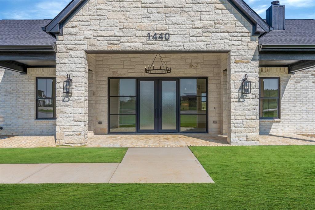 Stunning New Construction on 1 Acre – No HOA! Experience the perfect blend of luxury and country living in this newly built 3-bedroom, 2.5-bath home situated on a spacious 1-acre lot. Thoughtfully designed with soaring 12-foot ceilings throughout, including the garage, this home offers both comfort and style with high-end finishes and energy-efficient features. The chef’s kitchen is a true showstopper, featuring a 10’ x 4’ quartz island, full quartz backsplash, pot filler, vented range hood, and under-upper cabinet lighting—all designed for both function and elegance. A large walk-in pantry with under-cabinet lighting ensures ample storage. Enjoy the seamless flow of natural light through premium black Anderson windows (interior & exterior) and entertain with ease thanks to the black iron & glass sliding patio door and matching iron front door with side glass. The living room and all bedrooms are outfitted with recessed lighting and remote-controlled ceiling fans, with a chic chandelier gracing the front porch. Outside, you'll love the brick-floored patios in front and back, perfect for relaxing or entertaining. The oversized 2-car garage features an 8-foot insulated door, ideal for taller vehicles or extra storage. Built with full foam encapsulation for superior energy efficiency and comfort, and equipped with a heat pump HVAC system, this home is designed to save on energy while keeping you comfortable year-round. All this, with no HOA restrictions, just minutes from the Chisholm Trail Tollway, shopping, and dining—giving you the best of both country charm and city convenience.