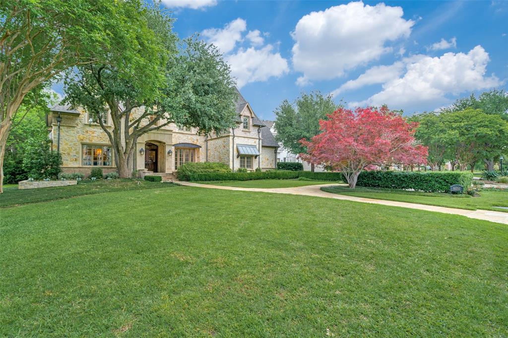 Beautifully maintained classic home in fairway of Preston Hollow! Lightly scraped hardwoods throughout and large windows let in much light.Large landscaped front yard leads to covered porch and lovely entry. Living and dining rooms flank foyer, which also leads to warm wood paneled library with great builtins and double sided fireplace. Large family room with beautiful vaulted and beamed ceiling has fireplace and wall of french doors leading to patio and rear yard. Family room opens to kitchen, also with beamed ceiling, builtin stainless appliances, large island and adjacent breakfast room. Downstairs primary bedroom overlooks rear yard and has spacious bath with dual sinks, large jetted tub, separate shower and spacious walk in closet. Secondary downstairs bedroom is off kitchen has adjacent full bath. Laundry and another smaller office also off kitchen. Upstairs there are 3 additional bedrooms with ensuite baths, another living area and gameroom. 3 car attached garage. Backhouse may become pool or guest house or storage. This home has everything and is close to shopping, restaurants, and schools!