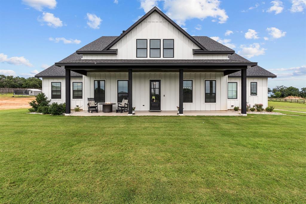 Gorgeous views frame this 5-bedroom, 4-bath modern-farmhouse masterpiece in Poolville ISD, crafted with elevated finishes and thoughtful design throughout. The open-concept main level showcases wood-beam accent ceilings, hardwood stairs, and a spacious living area anchored by a stunning custom fireplace with built-ins, creating a warm yet sophisticated focal point.
The chef’s kitchen blends beauty and function with premium quartz countertops, custom cabinetry, stainless steel appliances, and an oversized island designed for both culinary artistry and effortless entertaining. The luxurious primary suite features dual vanities, an oversized walk-in shower, and a generous wardrobe closet. Additional bedrooms are spacious and versatile, ideal for guests, multi-generational living, or private workspaces.
Step outside to a large backyard designed for relaxation and future outdoor living. The covered patio includes a 50-amp hookup ready for a hot tub, offering the perfect setting to unwind beneath wide Texas skies. A 3-car garage provides ample storage and convenience.
Set within a peaceful rural community (without an HOA) yet just minutes from Weatherford, Springtown, and Fort Worth, this home delivers a rare blend of luxury, space, and tranquility.
A residence of exceptional craftsmanship and comfort—perfect for those who expect more from where they live.