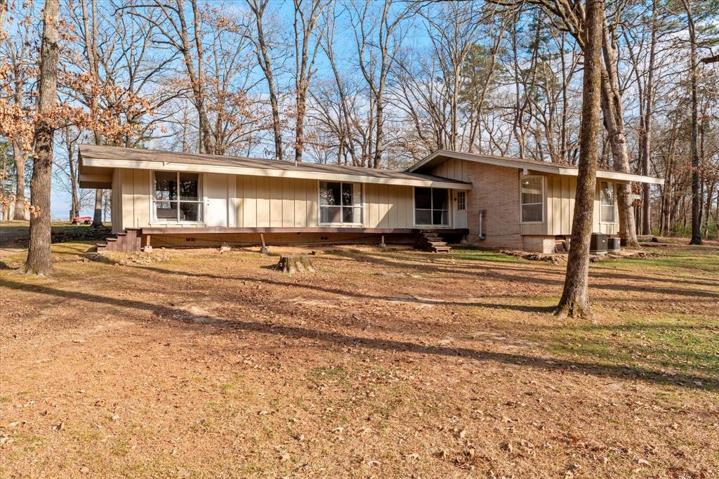Embrace the clean lines of this striking 3-bedroom, 2-bath Mid-Century Modern Ranch. Set on a serene, tree-shaded lot, this home features soaring vaulted ceilings and expansive windows that create a seamless flow with the outdoors. It is an architectural gem waiting for your creative touch to blend its vintage roots with modern flair. Enjoy a peaceful country feel within walking distance of Annie Sims Elementary and minutes from city amenities. A rare find with incredible potential—schedule your tour today!
