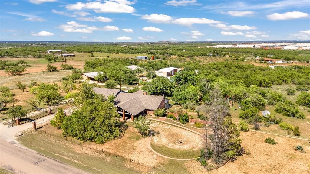 Exceptional opportunity featuring two separate properties at 3165 and 3175 Hayter Rd in Abilene for a total of 10 acres, ideally positioned near the rapidly expanding Lancium Crusoe AI campus and other major technology and data center developments in the area, while still offering a quiet and private setting.

The main residence features expansive entertaining spaces, 3 bedrooms, and a unique secondary kitchen and pantry area ideal for hosting, extended living, or flexible use. A heated and cooled garage is complemented by an additional attached garage with room for up to 4 vehicles.

The property also includes a guest house with living quarters and up to 2 rooms, creating excellent potential for guests, office space, or multi-generational living. Two large insulated shops provide exceptional workspace and storage with capacity for 10+ vehicles combined. Additional improvements include an accessory shed with bathroom facilities and multiple storage buildings throughout the property.

The majority of the items in the house could be negotiated turning this property into a truly turn key scenario for immediate occupation.

Approximately 2.5 acres of fenced pasture sits to the north and could be utilized for agriculture, livestock, equipment storage, or future expansion. Rare combination of residential comfort, extensive shop space, usable acreage, and strategic proximity to Abilene’s growing AI and technology corridor—all while maintaining a peaceful country atmosphere.