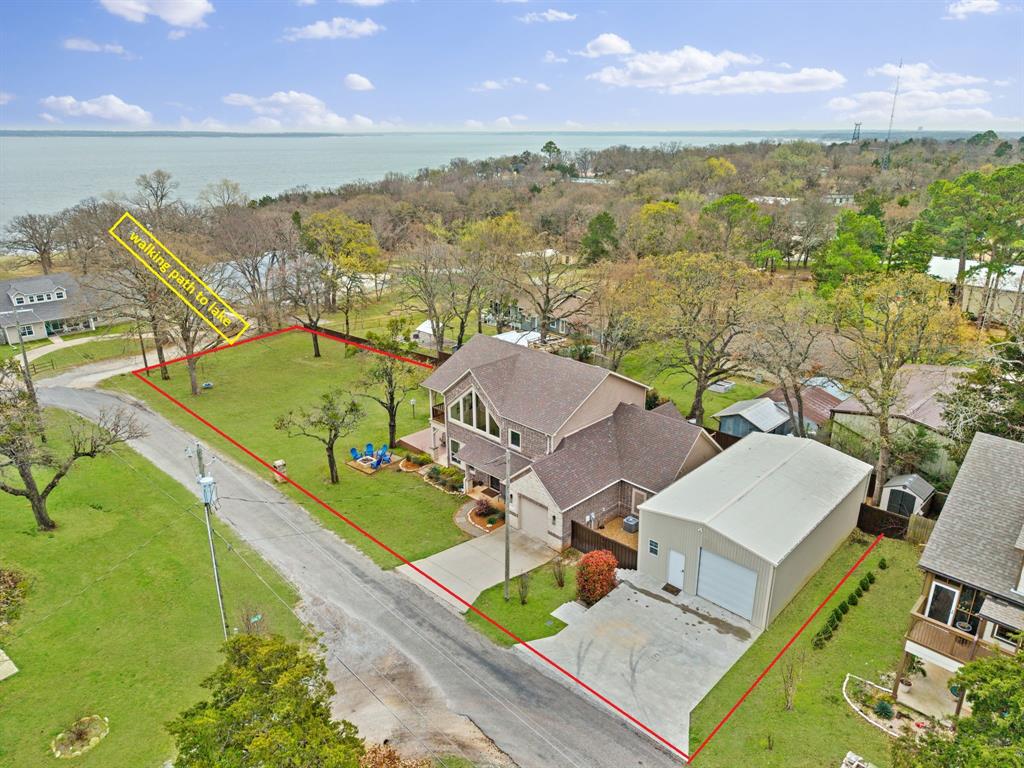 Custom builder’s personal home just a 2-minute walk to the Lake Texoma Beach Front in the prestigious Miller's Cove, situated on a corner lot of just over half an acre. This thoughtfully designed property features an open floor plan with vaulted ceilings and massive windows, filling the home with natural light and offering views of the water right from the living room. Enjoy outdoor living with a covered patio, private backyard, hot tub, and fire pit—perfect for relaxing evenings or entertaining guests. The property also includes an impressive 1,260 sq ft insulated shop with AC and private office space, plus epoxy floors throughout. The shop opening is 10.5 ft, allowing for a camper or boat storage. Whether you’re looking for a full-time residence, summer lake getaway, or an income-producing Airbnb, this versatile property offers comfort, style, and proximity to the lake in one exceptional package.