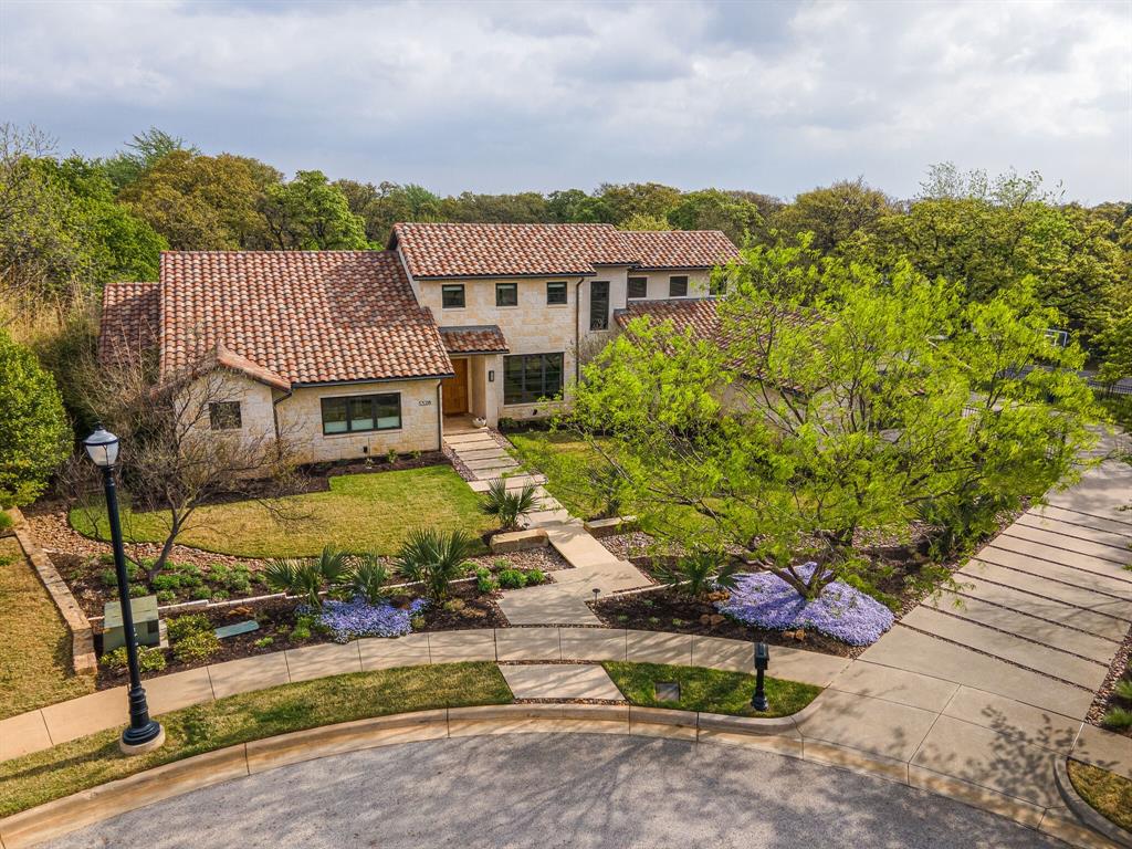 Welcome to this fabulous hill country contemporary home located in the luxury master-planned community of Westwyck Hills in Southlake, TX. The Mahogany door welcomes you to the clean lines, impeccable finishes & high quality craftmanship of this beautiful Austin stone home with hardwood floors throughout the downstairs. Enjoy two large downstairs living rooms that offer wonderful relaxing family spaces with views of the pool & ivory travertine patio. The well-organized kitchen features, white oak cabinets, Caesarstone countertops, glass backsplash & raised wood bar that simply invites you to spend time in the kitchen. The master suite leads to a peaceful spa inspired bath complete with natural limestone, contemporary blue tile & freestanding tub. Secondary bedrooms & game room create a great space upstairs for kids or young adults. This spectacular home is ready for both full-scale entertaining or private family time. Oversized lot, 3-car garage, and Exemplary Carroll ISD.
