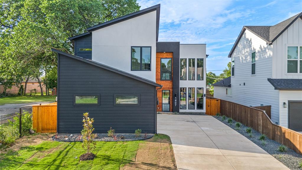 Experience elevated living in this architecturally striking modern contemporary residence ideally located just 8 minutes from Downtown Dallas. Spanning approximately 3,100 square feet, this thoughtfully designed home offers 4 spacious bedrooms, 4 full bathrooms, 1 half bath, and a rare 3-car garage.
Designed with both luxury and functionality in mind, the open-concept floor plan showcases soaring vaulted ceilings, expansive windows, and abundant natural light throughout. A dramatic floating staircase serves as a stunning architectural centerpiece, complemented by sleek modern finishes and clean contemporary lines. The gourmet kitchen anchors the home with custom cabinetry, premium appliances, a spacious center island, and seamless flow into the living and dining areas, creating an ideal setting for both everyday living and entertaining.
The private primary suite offers a tranquil retreat featuring a spa-inspired bath with dual vanities, an oversized walk-in shower, and generous walk-in closet space. Each secondary bedroom is thoughtfully appointed with its own en-suite bathroom, providing exceptional comfort and privacy for family and guests.
Throughout the residence, designer-selected finishes, sophisticated architectural details, and an abundance of natural light create a refined and inviting atmosphere. Conveniently located just minutes from Downtown Dallas, residents enjoy quick access to premier dining, entertainment, shopping, and major employment centers while enjoying the privacy of a residential neighborhood.
A rare combination of contemporary architecture, luxury amenities, vaulted ceilings, a dramatic floating staircase, and an unbeatable location make this exceptional home a standout opportunity in the Dallas market.