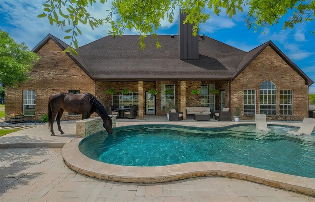 This Property is one of the most amazing you will find in Pilot Point.  Located at Friendship Road and 1385, giving quick access to Aubrey, Pilot Point, Celina, and DNT. This stunning property is 2.86+ acres surrounded by over 1,600 ft of pipe fencing.  The Property sits behind an electric gate and features a 2,640 sq ft home with 4 bedrooms and 3 full baths. The 4th bedroom can be an office, a fitness room, a kids' playroom, or a flex space with a Murphy Bed, overlooking the pool and pasture for a spectacular view. The living area opens to the dining and kitchen area, featuring a beautiful wood-burning fireplace with a gas lighter and blower fan. The kitchen boasts two islands that provide ample storage, a walk-in pantry, and a new Jenn-Air Schott Ceran Cooktop with a downdraft and exterior vent. The view from the kitchen window is breathtaking. The oversized laundry room is located off the garage with a sink and additional storage. The outdoor living area has a large covered back porch overlooking the inground pool built in 2023 with a heater, waterfall, LED lighting, and tanning ledge.  Pool lighting is run off an app. The 36 x 36 barn has 5 stalls plus an air-conditioned tack room. Both the house and the barn have spray foam insulation. This kept the water inside the barn from freezing during the January freeze. The carport is designed to hold equipment and measures 30 ft wide and 12 ft tall. The barn has a separate electric meter with an RV hookup.  In the rear, the riding ring and arena have improved drainage, crown grading, and perimeter drains. 10 loads of arena sand have been brought in to make this ideal for horses. The 32-ft-wide garage has room for 2 cars and plenty of other toys. The lawn inside the fence in the front, side, back, and around the pool has a 12-zone sprinkler system. The house is fenced off from the pastures. Truly a one of a kind. TAX RATE is an incredible 1.12%.