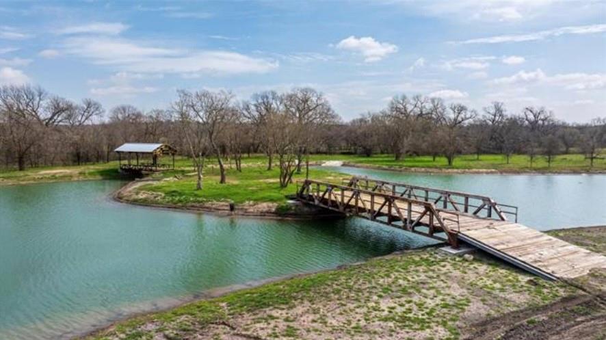 Recently permitted and lifted out of the flood zone, and strategically positioned along I-20 and the Clear Fork of the
Trinity River, this 52.3-acre tract in rapidly growing Willow Park, Texas offers unmatched visibility, access, and
development flexibility. It also lies within the county’s planned improvements for the new Bankhead Bridge and future
two-way access—enhancing connectivity and increasing long-term value. Whether you’re planning: Ranchettes with access to the Clear Fork of the Trinity River for private estates or resale; Buildable acres for light industrial, warehouse, or flex space and yard use, contractor laydown, or equipment storage; A residential community in a high-demand corridor — this site is primed for action. City water, sewer, and electric are already available at the front of the property. Floodplain mitigation is complete, and bridge and lake amenities are already in place, offering both functional infrastructure and aesthetic value. The property lies outside city limits but is annexation-ready. Located just 25 minutes from Fort Worth and 15
minutes from Historic Weatherford, this property is ideal for developers, investors, and operators seeking shovel-ready land in one of Parker County’s most strategic growth corridors.