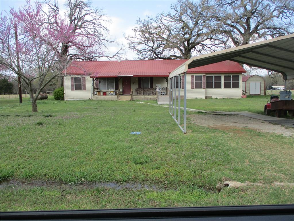 County Farmhouse on one-acre, large trees in yard, covered front porch, 3 or 4 bedrooms, 2 baths, wood burning stove in large living room, kitchen and dining area, bonus room could be used an office or 4th bedroom.  Nice storage build, plus small shed of tools and lawn equipment. Quite area, just minutes from town, schools, shopping, Lake Fork or Lake Tawakoni. Come check this one out. Being sold As-is, so bring your ideas and move to the country.