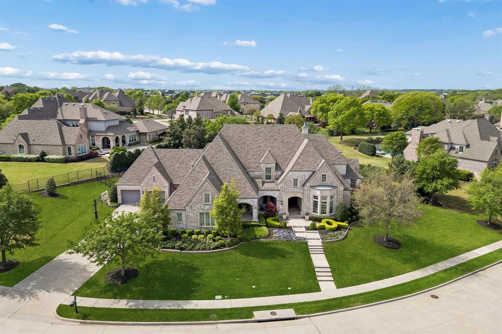 Gorgeous estate in the highly sought after Serenity Community, zoned to acclaimed Lovejoy ISD. Perched on an expansive .71 acres, this 5 bed, 8 bath home offers an exceptional layout, privacy, and refined living. The home's design offers flexibility with first floor media and game room, and a separate guest suite for multigenerational living. There is so much to love here, including beautiful hardwood floors throughout, accordion slider doors, wolf and subzero appliances, ensuites for all bedrooms, beautiful lighting, a fabulous laundry room, and the stunning backyard. Her owners have spared no expense on the amazing backyard with impeccable landscape, travertine deck, outdoor kitchen and bar, linear fireplace and seating area, and massive covered patio with phantom screens. Serenity is a lovely enclave of custom homes adjacent to the Heard museum and nature preserve, and  ideally located just minutes from Sam Rayburn Tollway and 75 and all retail, shopping and restaurants.