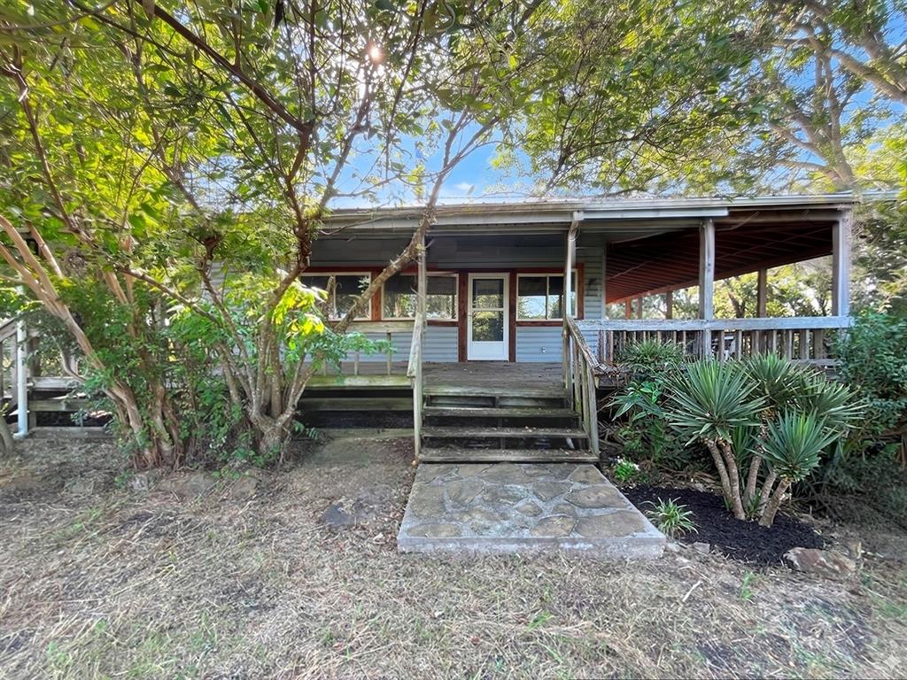 Acreage, Acreage, Acreage… Experience this rare opportunity to own a charmingly rustic 3-bedroom, 2-bath farm-style residence set on 5 amazing acres in McLendon-Chisholm. A wide, welcoming covered porch introduces the home with timeless charm and sets the stage for country-style living. Inside, the spacious living room centers around a striking rock fireplace, creating an inviting focal point for gatherings. The nicely appointed kitchen and thoughtfully placed dining area offer a seamless blend of comfort, warmth, and everyday functionality. The property’s exterior amenities elevate its appeal, including a 3-car detached garage, a generous storage or workshop building, a barn ready for your animals, and a serene pond that enhances the landscape with natural beauty. With 5 acres at your disposal, you’ll enjoy ample space to roam and the potential for an additional dwelling if desired. Perfectly positioned near Rockwall, you’ll enjoy convenient access to schools, shopping, dining, entertainment, medical services, and more, all while maintaining the tranquility of a rural-like retreat. Quick access to I-30 facilitates a pleasant commute. This is a Fannie Mae HomePath Property…View it today.